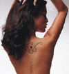 girl with tattoo between shoulder blades